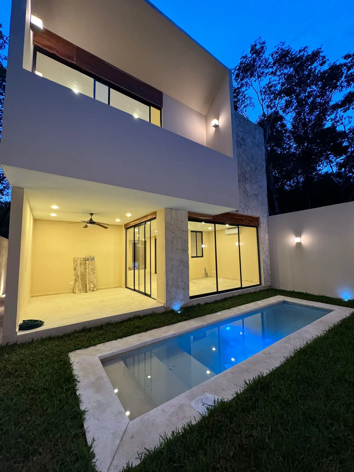Rear facade and pool at dusk – 3-bedroom house in Residencial Valenia, Playa del Carmen