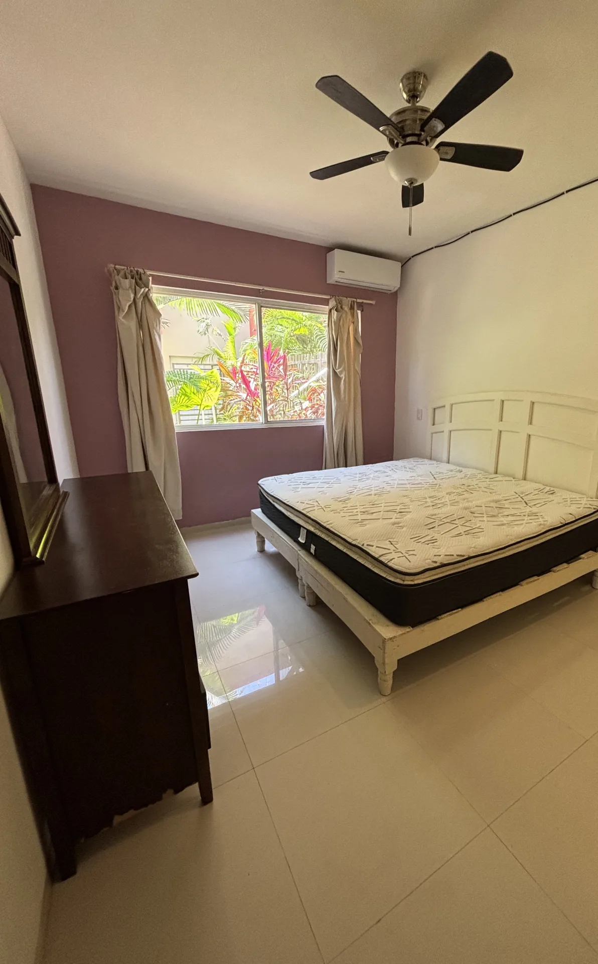 Primary bedroom with garden-view window – 2-bedroom condo in Playacar Phase 2