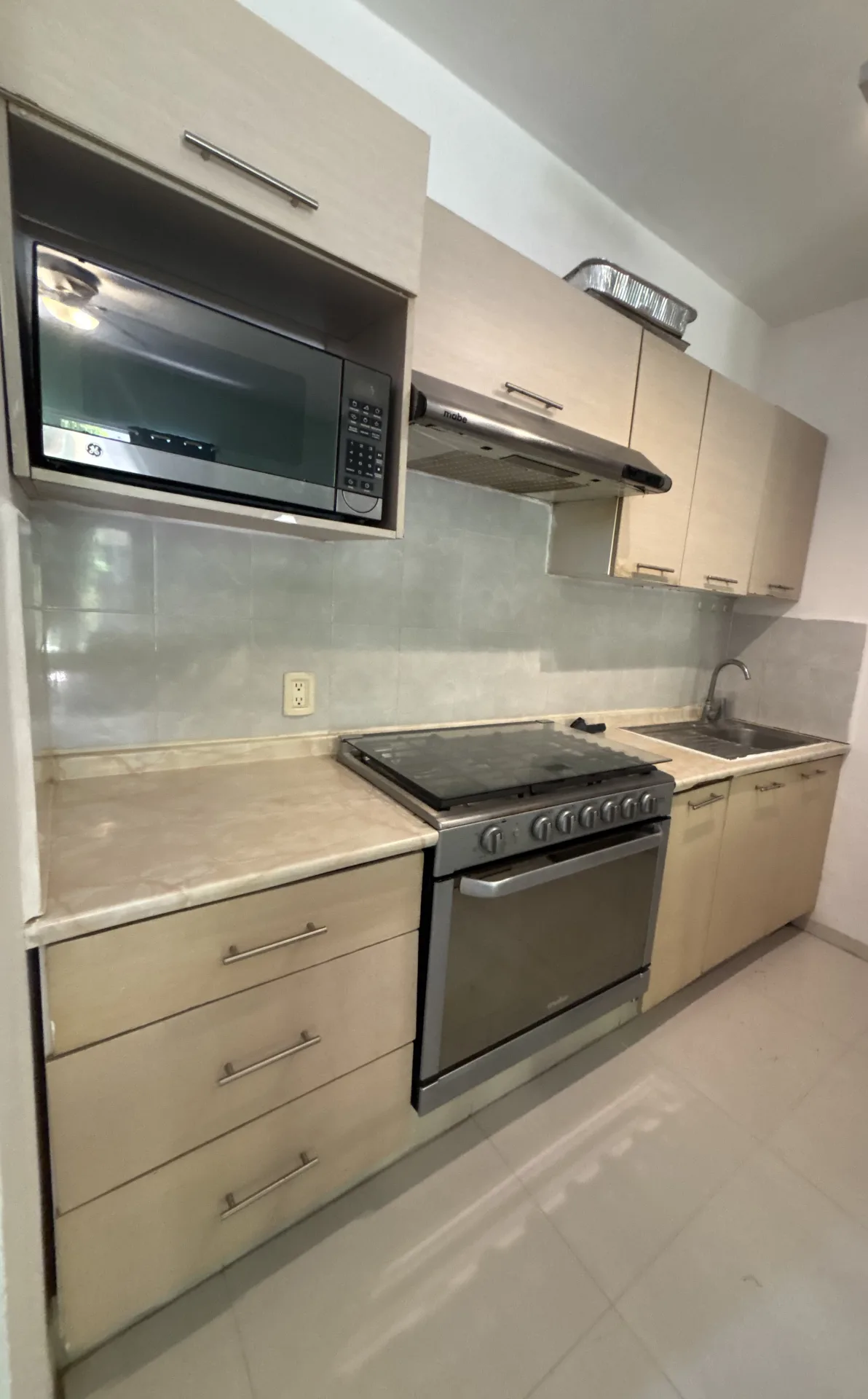 Kitchen with stove and microwave – 2-bedroom condo in Playacar Phase 2