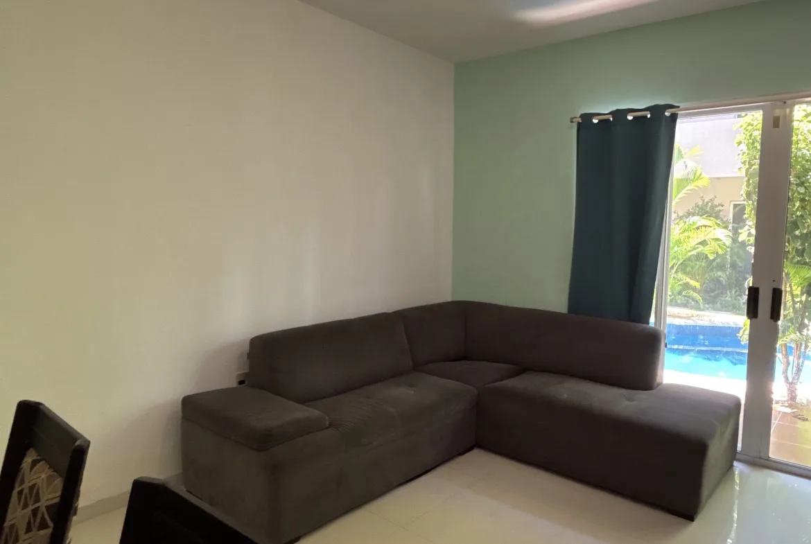 Living room with pool views – 2-bedroom condo in Playacar Phase 2