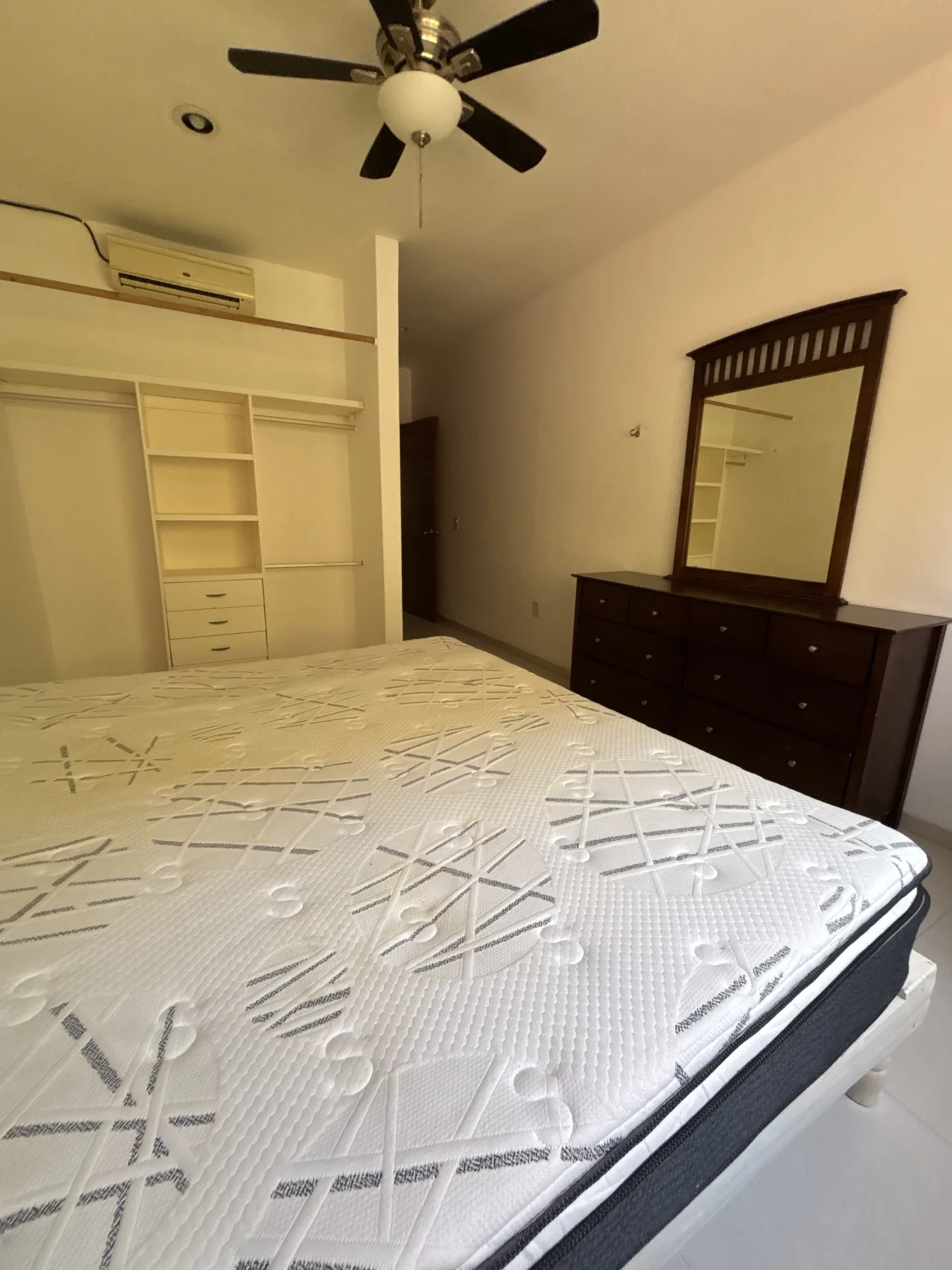 Bedroom with built-in closet and dresser – 2-bedroom condo in Playacar Phase 2