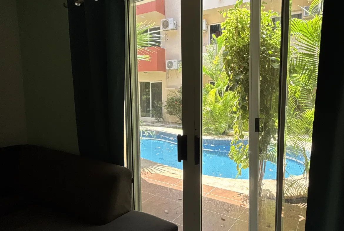 Living room opening onto the pool – 2-bedroom condo in Playacar Phase 2