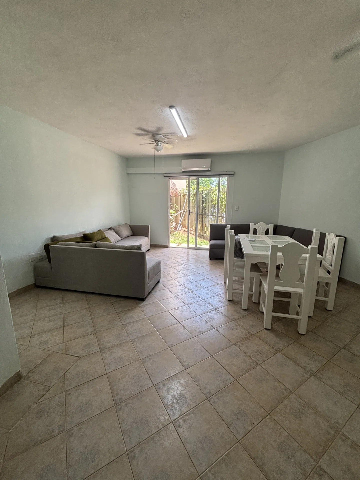 Living room opening onto the terrace – 2-bedroom condo for rent in Playacar Phase 2