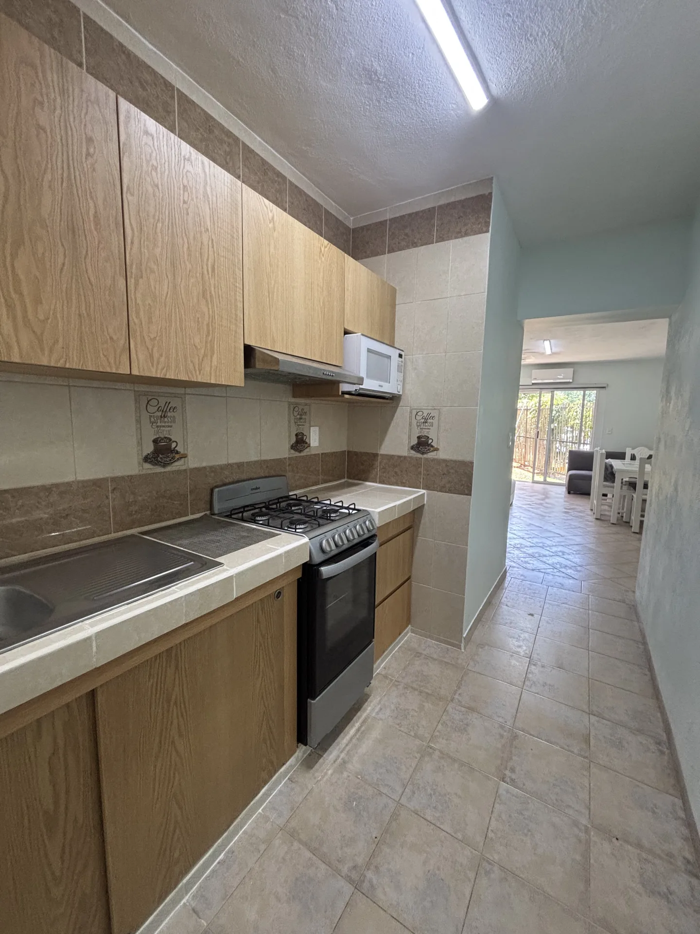Kitchen and hallway – 2-bedroom condo for rent in Playacar Phase 2