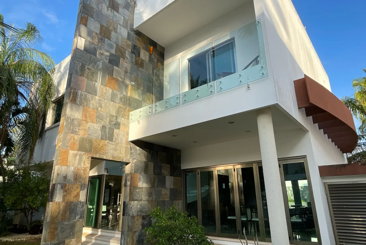 Two-story facade with stone wall and balcony – 5-bedroom house in Villa Magna, Cancun